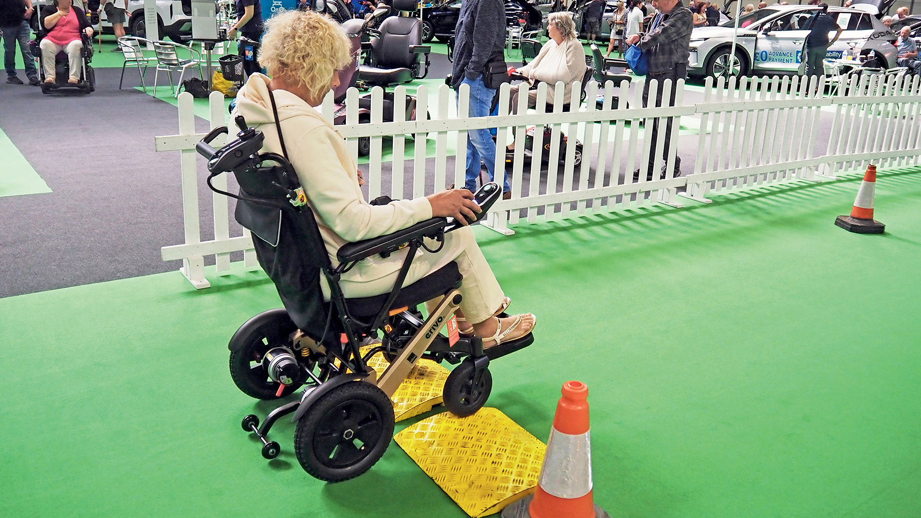 Individual using power wheelchair at community event